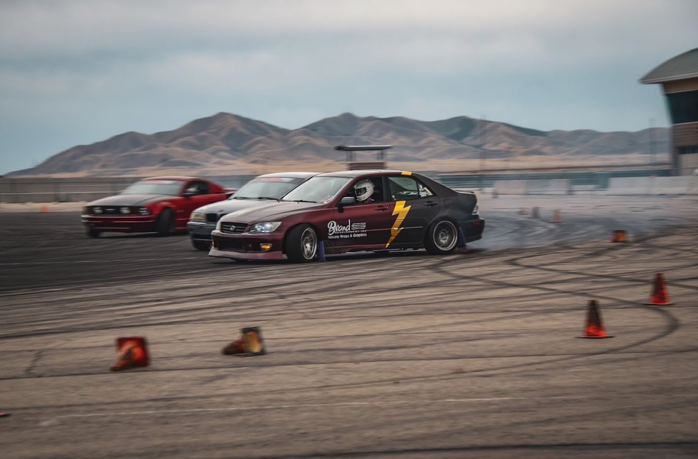 Clipping Point sponsored car sliding through a track day course