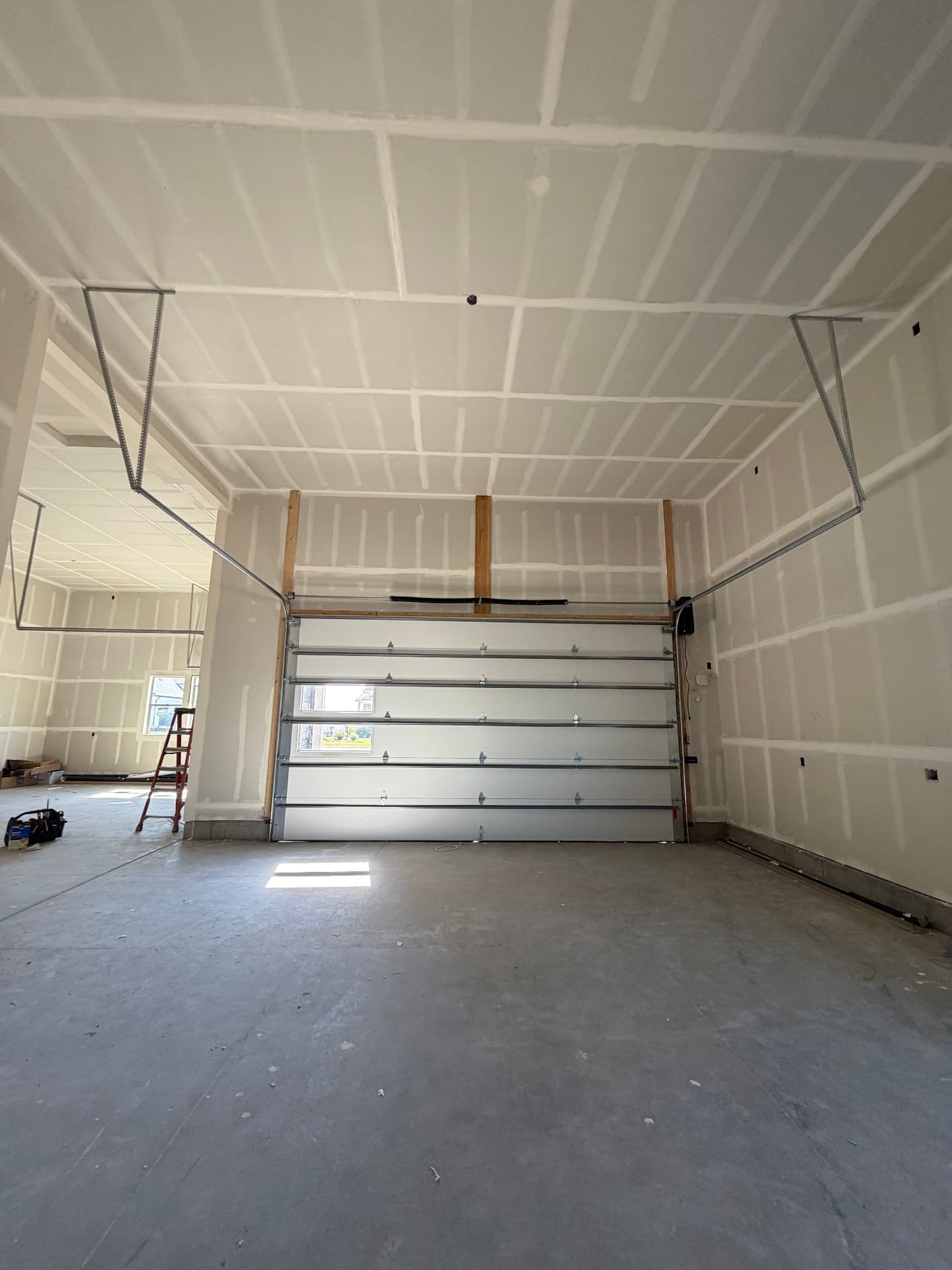 Freshly installed insulated garage door inside a new-build garage